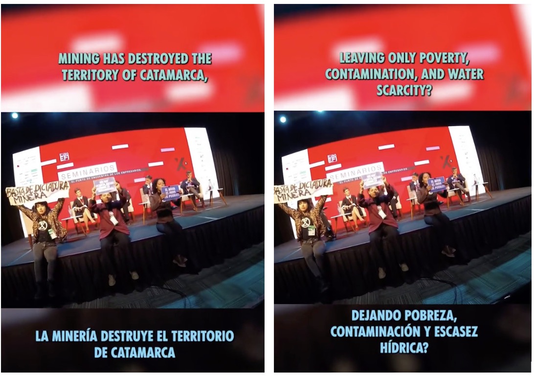 Photo of a stage panel discussion with red background screens displayingbilingual protest messages about mining's negative impact onCatamarca.